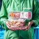 Multiresistente Keime in Fleisch: Greenpeace-Mitarbeitet hält verpacktes Fleisch
